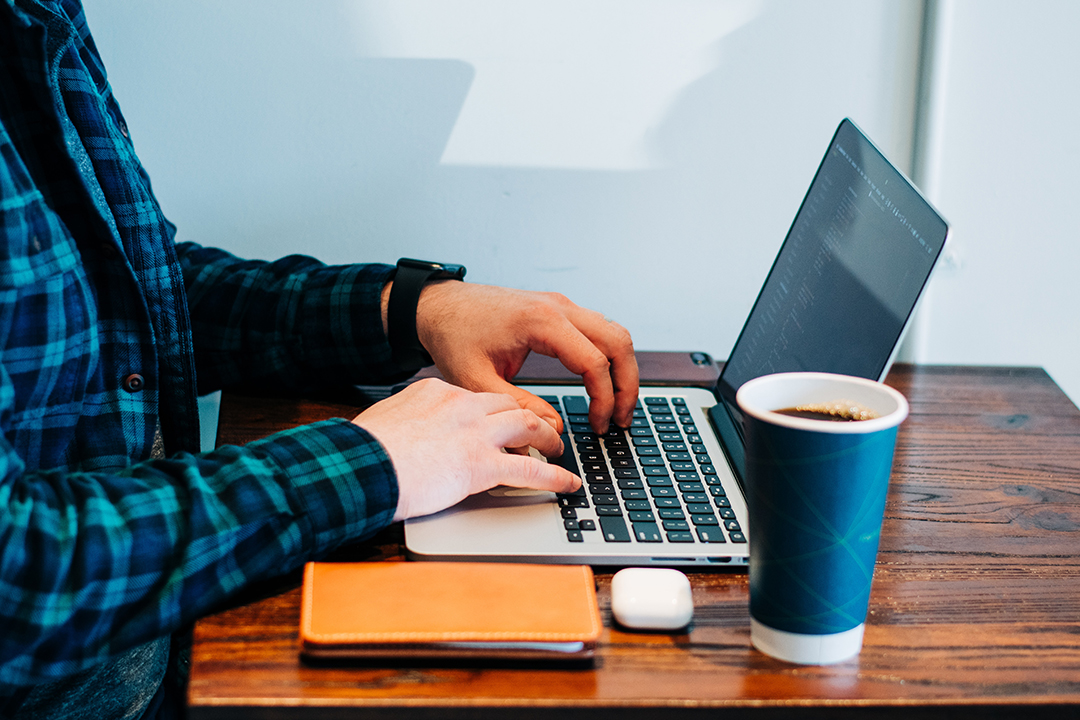 Close up of a person using a laptop