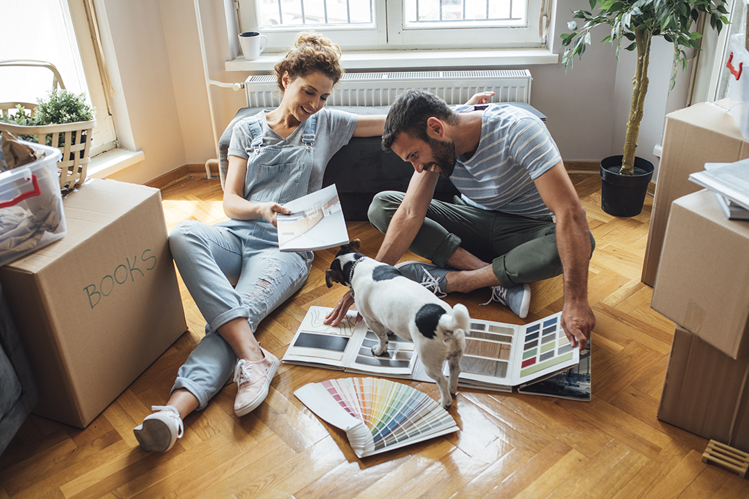 Husband and wife and their dog moving in new home.