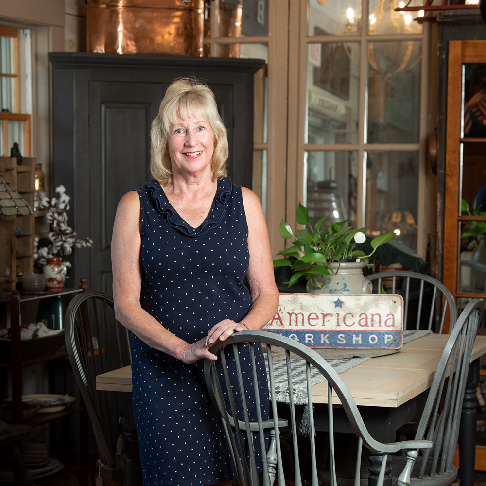 Photo of Cindy Hamilton Standing at a table and smiling.