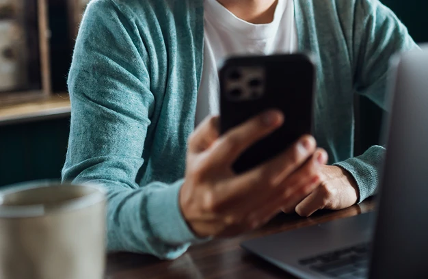 woman in a cafe using her smartphone
