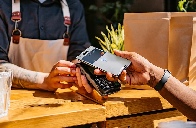 Person paying with their smartphone at a store